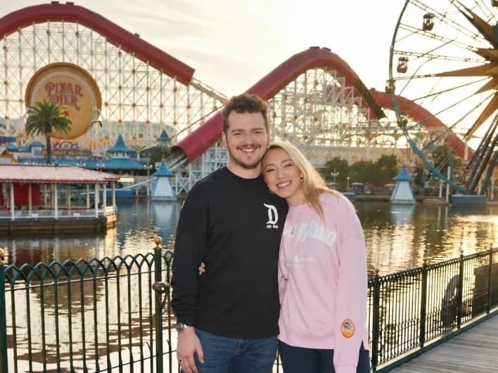 Chase and his wife on the boardwalk at Pixar Pier, Disney California Adventure
